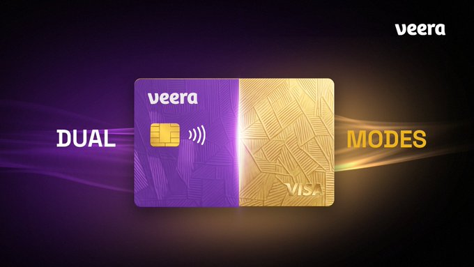 A Veera Visa credit card is split visually down the middle, with a purple "debit" half on the left under the label "DUAL" and a gold "credit" half on the right under "MODES," illustrating the card's Dual Spending Mode that lets users tap their balance directly while also borrowing against crypto collateral without selling.