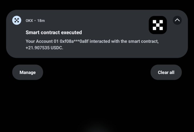 A smartphone notification from OKX showing a smart contract execution for +21.907535 USDC, with 'Manage' and 'Clear all' options visible.