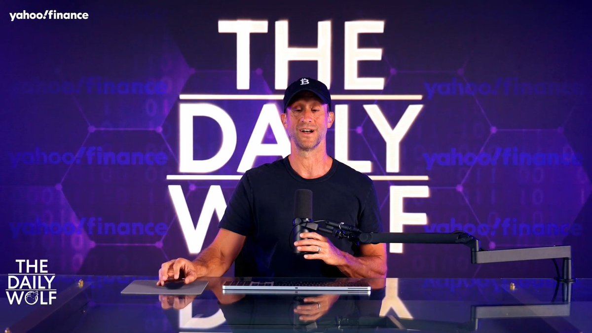 Scott Melker hosts "The Daily Wolf" on Yahoo Finance, appearing on screen with the show's logo and Yahoo Finance branding visible in the background. The setup suggests he's delivering breaking news about the BitMart crypto exchange shutdown and withdrawal issues, consistent with the post's description of him breaking down the story for viewers.