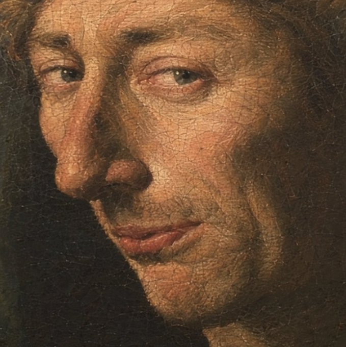A close-up detail of an old oil painting depicting a person's face, highlighting the cracked texture of the aged canvas.