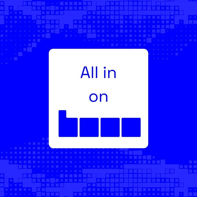 A blue graphic with a white square containing the text 'All in on boom' styled with the 'b' being larger, set against a pixelated blue background.