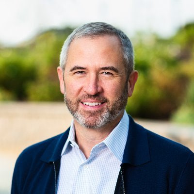 Brad Garlinghouse, CEO of Ripple, smiles outdoors in a professional headshot, complementing his statement that the U.S. is close to becoming the global crypto capital.