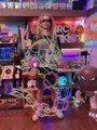 A 50-hour craft project featuring an elaborate KAWS-inspired figure with X-eyes, constructed from cardboard, plastic bottles, and other recycled materials, displayed in a workshop setting. The handcrafted sculpture showcases a colorful, layered design that reflects the dedication mentioned in the post, with the creator hoping their detailed work won't go unnoticed.