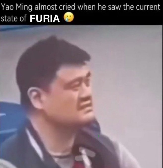 The image is a low-quality close-up screenshot of former NBA player Yao Ming with a shocked, almost tearful expression, paired with the caption "Yao Ming almost cried when he saw the current state of FURIA 😳." It relates to the post by serving as a meme reaction to FURIA's poor CS2 performance—suggesting the team's situation is so dire that even Yao Ming would be moved to tears, while the post adds humor by joking that FURIA isn't even visible in the image, emphasizing how "cooked" the team's current state is.