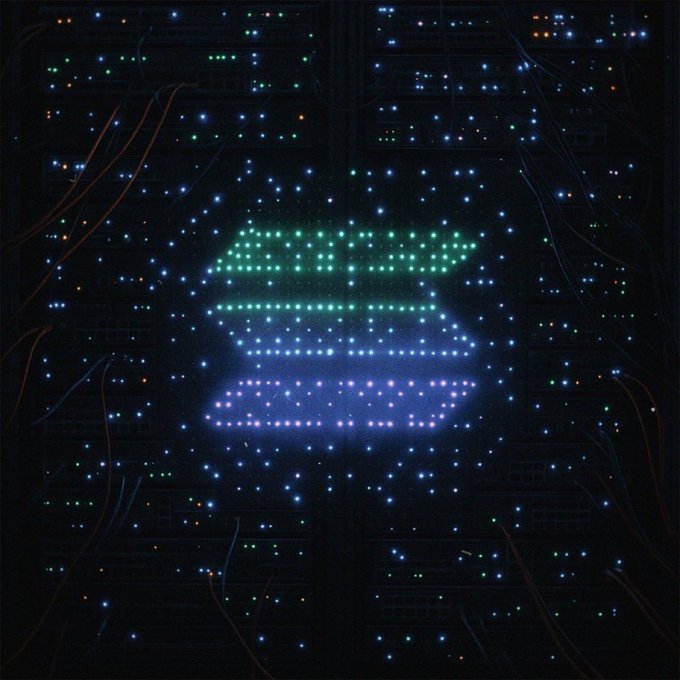 A dark circuit board illuminated by glowing LEDs forms the recognizable Solana logo at the center, with cascading blue and purple light trails radiating outward like a digital aurora. The hardware-inspired design visually reinforces the post's declaration that "solana is forever," portraying the blockchain as an enduring, foundational piece of technology.