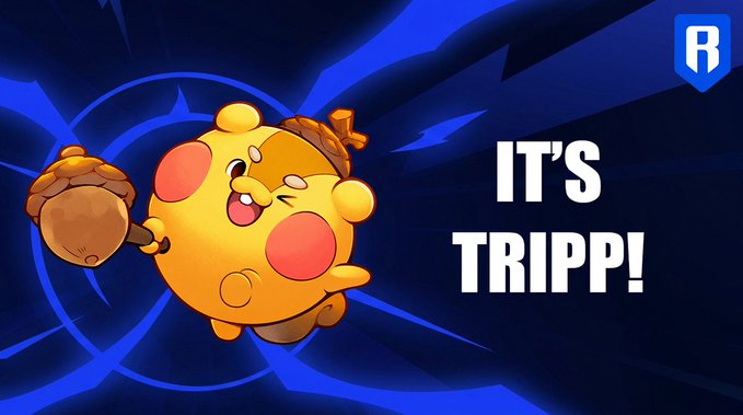 A promotional graphic features a cartoonish yellow creature with rosy cheeks and clawed gloves against a dynamic dark blue background with swirling patterns. The bold text "IT'S TRIPP!" appears on the right side, introducing the character referenced as Tripp from Axie Infinity in the accompanying post, with an "R" logo visible in the top right corner.