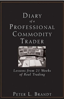 The image shows a book cover titled "Diary of a Professional Commodity Trader: Lessons from 21 Weeks of Real Trading" by Peter L. Brandt, featuring a photo of trading monitors in the center. The book relates to the post as it appears to be the prize being offered to the trader who provides the best answer about the biggest problem in trading.