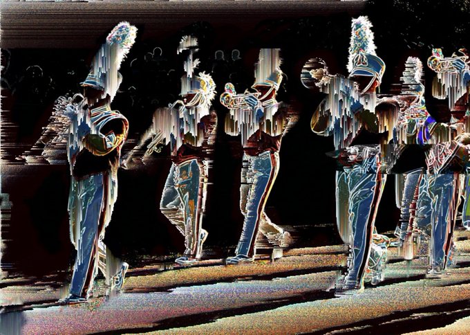 A heavily distorted, glitch-art image shows a marching band in uniforms with plumed hats, their forms fragmented with vertical streaks of color.