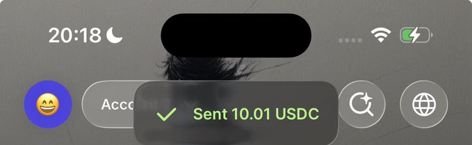 An iPhone screenshot displays a green confirmation notification reading "✓ Sent 10.01 USDC" overlaid on the lock screen, verifying the cryptocurrency prize transaction mentioned in the accompanying post. The interface shows the time as 20:18 with full Wi-Fi and battery indicators, along with app shortcuts for what appears to be a crypto wallet or web browser.
