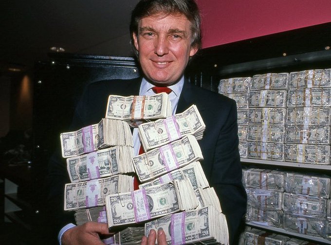 The image features a man dressed in a suit, standing next to a large stack of money. The man appears to be smiling as he holds up the money for the camera. The background reveals that there are numerous stacks of money behind him, indicating a significant amount of wealth or financial transactions taking place. The text in the image suggests that this is related to cryptocurrency and the recent passing of the CLARITY Act, which has given banks access to Bitcoin and other cryptocurrencies. This development could potentially change the way people think about money and banking systems, as it opens up new possibilities for financial transactions and investments.