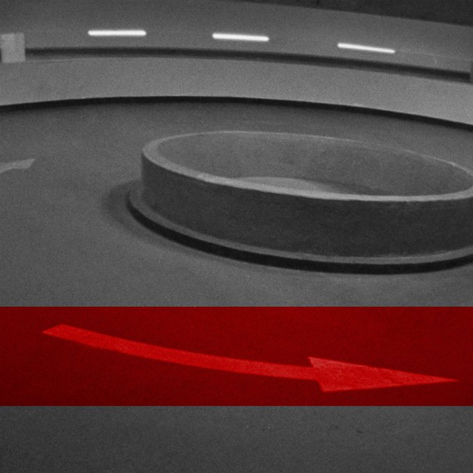 A stylized image with a grayscale top portion showing a circular platform or fountain, and a red bottom section featuring a red arrow pointing right.