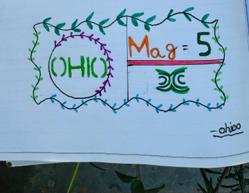 A hand-drawn sign with floral borders displaying 'OHIO' in a green circle on the left and 'Mag = 5' over a DC logo on the right, signed '_ohioo'.