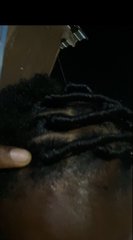 A fresh haircut being styled with a trimmer on dark hair, showing detailed line work and a clean fade. The close-up showcases the barbershop craftsmanship that made the 2000 naira expense feel worthwhile.
