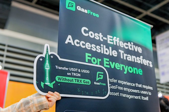 A person holds a rocket-themed sign reading "Transfer USDT & USDD on TRON Without TRX Gas" at the GasFree booth, with a large banner behind promoting "Cost-Effective Accessible Transfers For Everyone." The image illustrates GasFree's GWDC 2026 Korea appearance, showcasing how the service enables gas-free stablecoin transfers on TRON without requiring users to hold TRX.