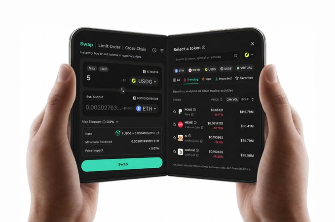 Hands holding a foldable smartphone displaying a crypto swap interface trading USDG for ETH with various token listings.
