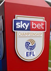 A close-up shot shows a red podium or barrier featuring the 'sky bet CHAMPIONSHIP' logo and the 'EFL' (English Football League) crest.