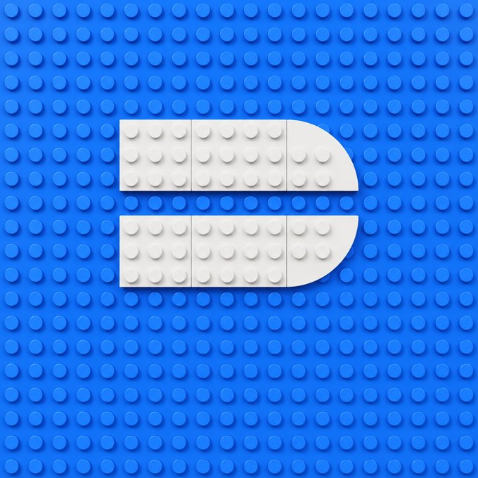 A stylized letter "D" formed by white LEGO-like bricks sits against a blue pegboard background, visually representing the "DeepBook" trading platform mentioned in the post, where the modular building blocks symbolize how DeepBook provides the foundational pieces (matching engine, liquidity, and volume) for assembling a trading platform.
