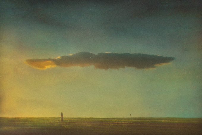 A atmospheric landscape painting showing a solitary figure standing in a vast, flat plain beneath a dramatic, elongated cloud illuminated by the warm light of a setting sun.