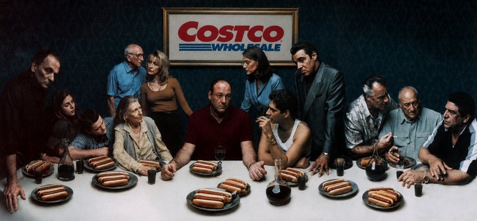 The image is a parody of Leonardo da Vinci's "The Last Supper," featuring a group of solemn individuals seated and standing around a table laden with plates of hot dogs, with a large "COSTCO WHOLESALE" sign displayed prominently on the wall behind them. This visual directly references the accompanying post's promotion for "$HOTDOG" and its association with Costco's iconic hot dog deal and membership, cleverly blending religious art parody with meme culture branding.