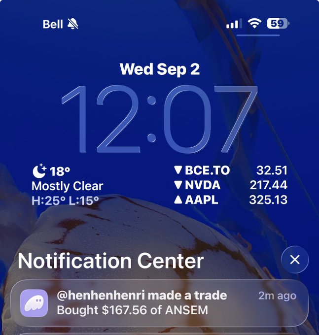 An iPhone lock screen showing the date "Wed Sep 2" and time "12:07" along with weather (18° Mostly Clear) and stock tickers including BCE.TO (32.51), NVDA (217.44), and AAPL (325.13). A Notification Center alert from Discord shows user "@henhenhenri made a trade" and "Bought $167.56 of ANSEM" 2 minutes ago.