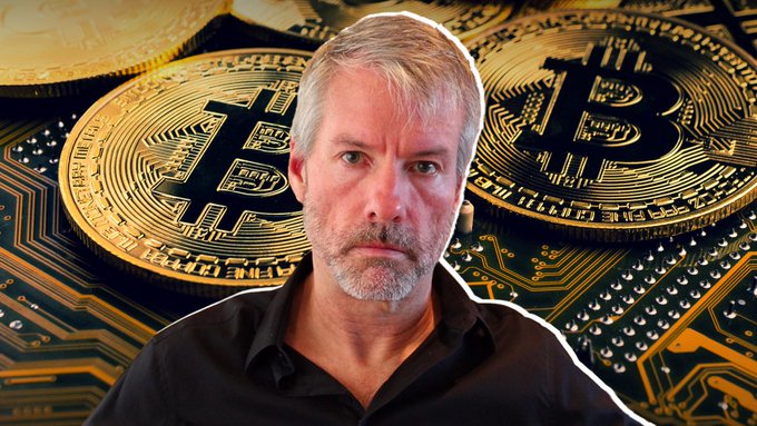 A photo of Michael Saylor, with gray hair and beard wearing a black shirt, superimposed over a background of gold Bitcoin coins and circuit board imagery.
