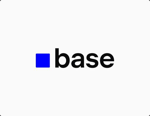 The image shows the Base logo, featuring a blue square next to the word "base" in black lowercase text on a light gray background. It relates to the announcement as Base's branding accompanies news of the B20 token standard launch on the Base ecosystem.