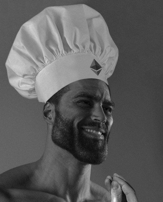 A black and white photo of a smiling bearded man wearing a chef's hat featuring an Ethereum logo.