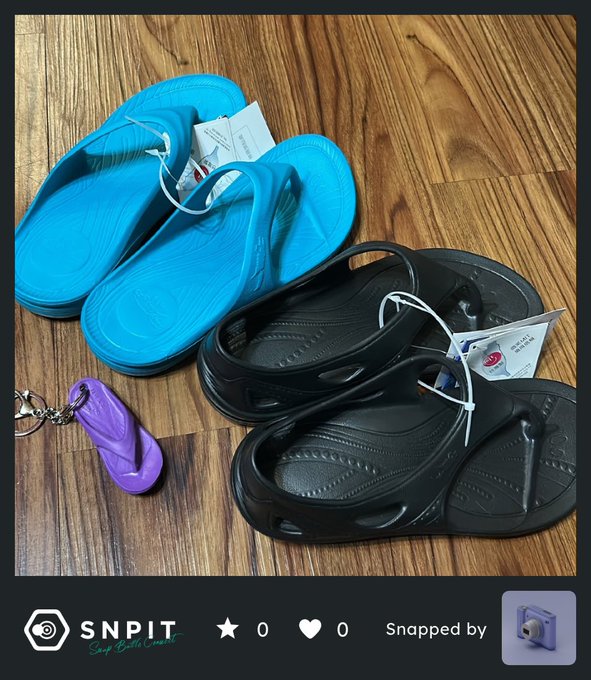 A snapshot from the SNPIT app showing a pair of blue Crocs, a pair of black Crocs, and a purple Croc keychain displayed on a wooden floor, with tags still attached to the footwear.
