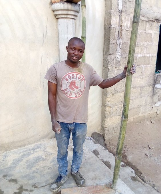 A man wearing a "Boston Red Sox" t-shirt stands in front of a building under construction, holding a bamboo pole, reflecting the post's message of perseverance and faith in changing one's current circumstances through hard work (symbolized by the building project) and time.