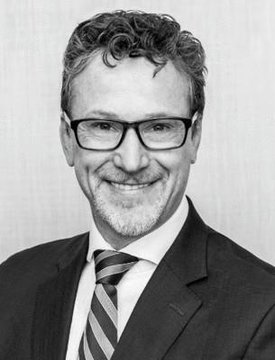 The image features a man wearing glasses, a suit, and a striped tie. He has a big smile on his face as he looks directly at the camera. The caption below the photo reads "Buy more $XRP". This suggests that there might be an ongoing trend or event related to cryptocurrency in the market, possibly influencing the price of Bitcoin or other digital assets.

The man's attire and expression convey a sense of confidence and professionalism, which could be associated with his role as a businessman or financial expert. The caption about buying more $XRP indicates that there might be an interest in investing in cryptocurrencies like Bitcoin, given its potential for growth and increased value over time.