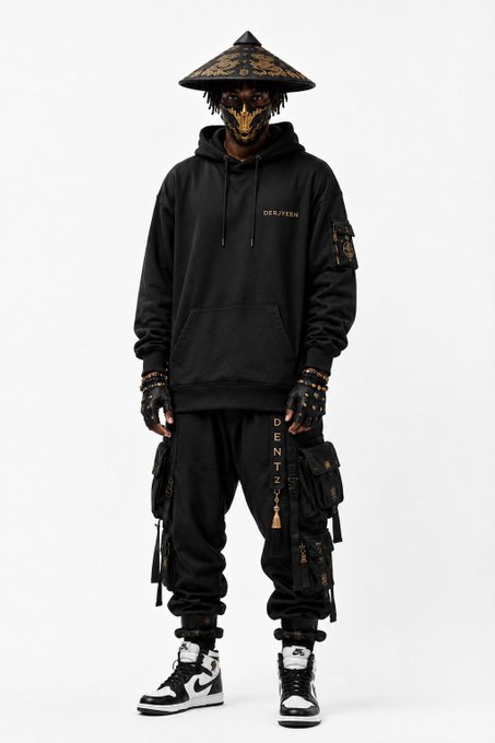 A figure wearing a black streetwear outfit including a gold-and-black patterned hat, a black hoodie reading 'DENITEN', cargo pants with gold lettering, fingerless gloves, and black-and-white high-top sneakers (Air Jordan 1s).