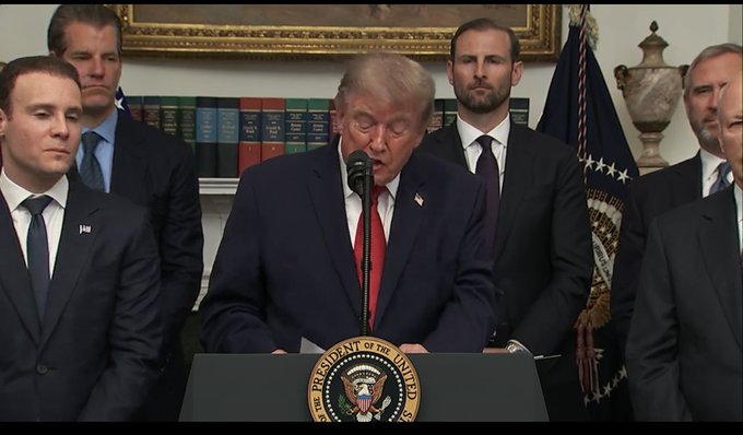 Donald Trump is seen speaking at a podium with the Seal of the President of the United States visible. The image relates to the post "@bgarlinghouse is in the house!" by showing a prominent figure in government, suggesting a potential meeting or event where Mr. Garlinghouse might be present.