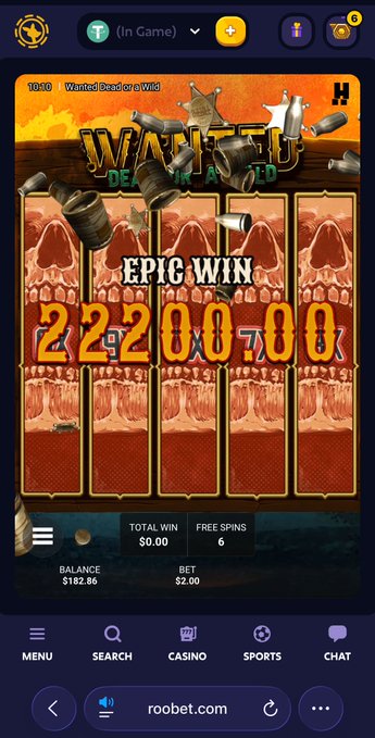 A mobile slot machine game called 'WANTED Dead or a Wild' displays an 'EPIC WIN' of 22200.00 on roobet.com.