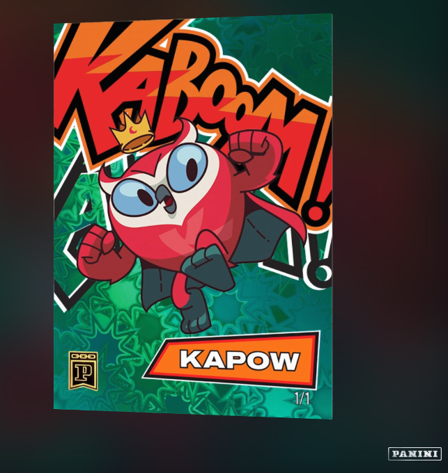 Panini trading card featuring a cartoon red character wearing a crown, with 'KAPOW!' comic-style text and labeled '1/1', branded with the Panini logo.