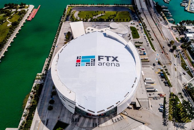 An aerial view of the FTX Arena in Miami, a large circular white-domed stadium located near the waterfront.