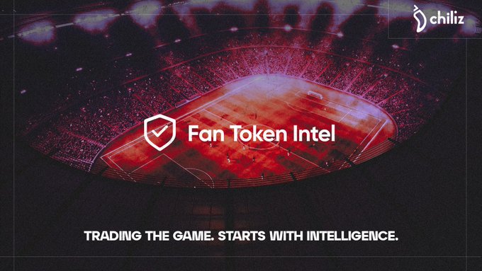 A stadium bathed in red light serves as the backdrop for a "chiliz" branded banner featuring a shield icon and the text "Fan Token Intel," with the tagline "TRADING THE GAME. STARTS WITH INTELLIGENCE" displayed below. The image visually reinforces the post's message about AI agents gaining market intelligence and historical context before matches, symbolizing the data-driven decision-making behind Fan Token™ trading.