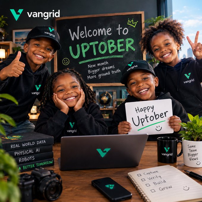 A promotional image for "vangrid" featuring smiling children in branded apparel around a chalkboard reading "Welcome to UPTOBER," with books labeled "REAL WORLD DATA," "PHYSICAL AI," and "ROBOTS."