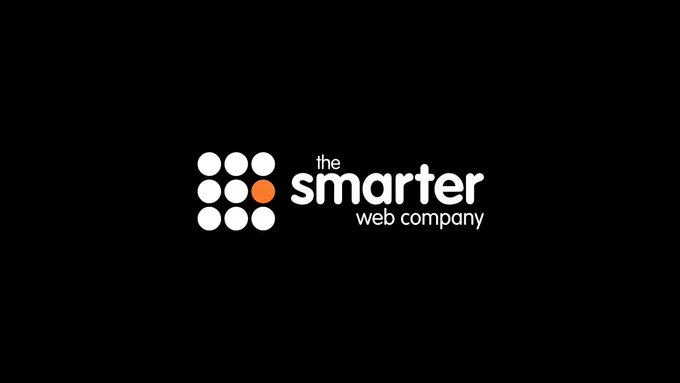 The Smarter Web Company logo featuring a 3x3 grid of white circles with one orange circle, displayed against a black background. The image represents the company that recently sold 177.89 bitcoin to repay $11.7 million to TOBAM ahead of schedule.
