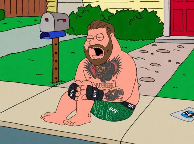 The cartoon shows a bearded, tattooed man wearing UFC gloves and shorts, sitting shirtless on a sidewalk in front of a house, screaming with his eyes closed in a disheveled state, likely depicting Conor McGregor after a night of partying with a smashed phone on the ground.