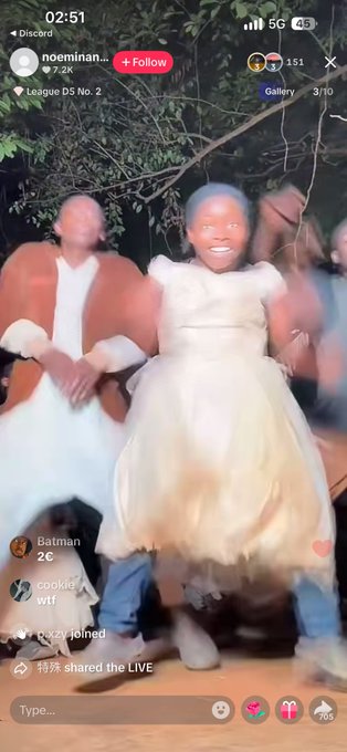 A TikTok Live video screenshot showing a young girl in a white dress dancing with men in what appears to be a cultural performance, with the username 'noeminan...' and the song 'League D5 No. 2' visible.