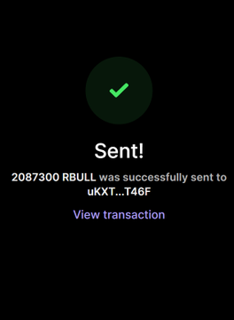 A successful transaction confirmation showing "Sent! 2087300 RBULL was successfully sent to uKXT...T46F" with a green checkmark and "View transaction" link, suggesting the sender purchased the RBULL tokens mentioned in the giveaway post to enter the contest.