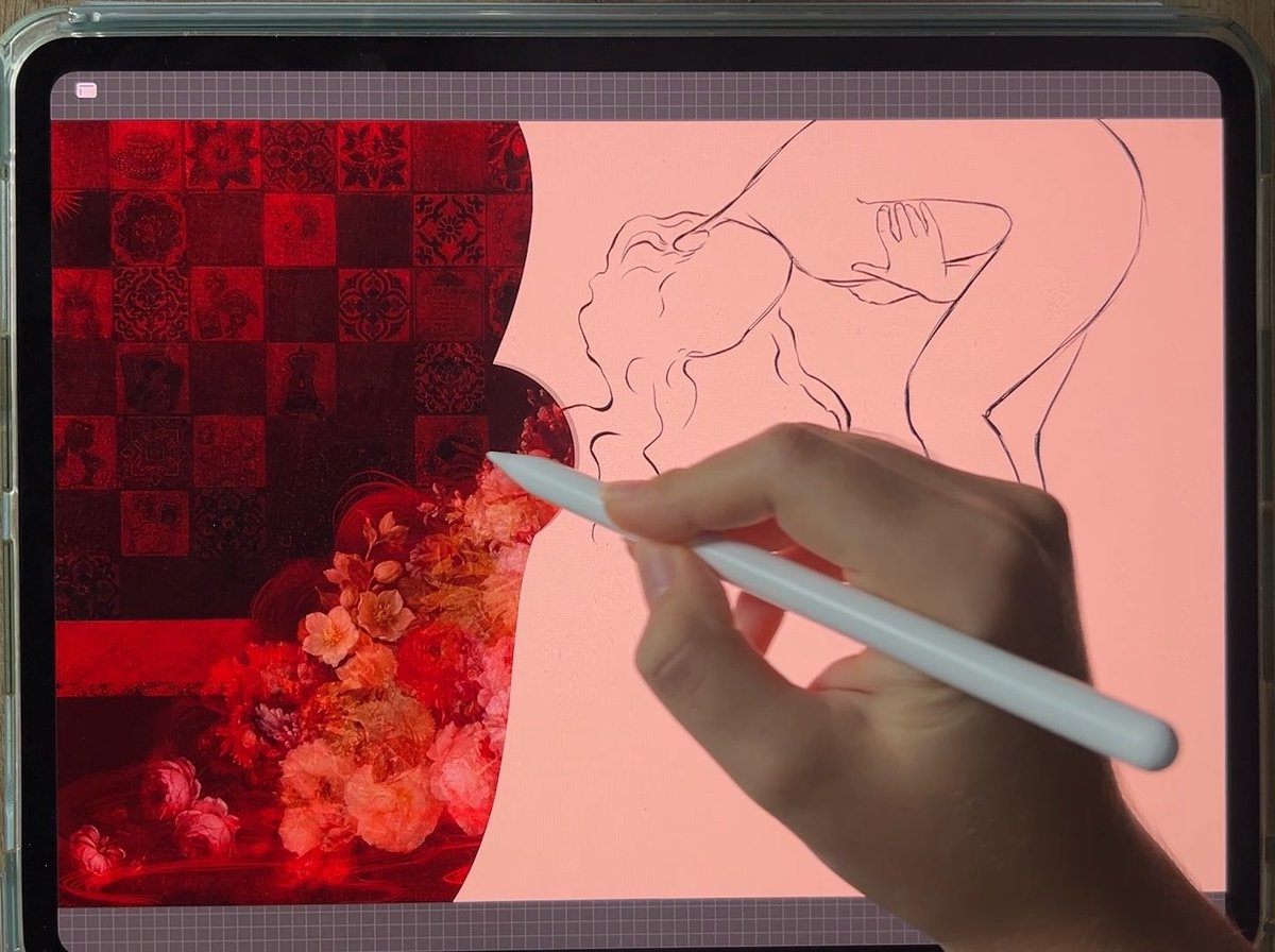 A hand holding a white stylus draws a line-art figure on a tablet, with red floral and patterned collage elements on the left side of the screen.