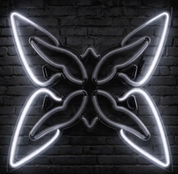 A glowing white neon butterfly is mounted on a dark brick wall. The image has no direct relation to the post about the quipnetwork Node Manager v0.2.3 update.