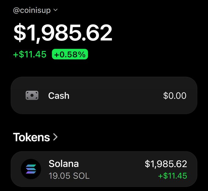 A crypto portfolio display for @coinisup shows a balance of $1,985.62 (+$11.45, +0.58%), held entirely in 19.05 SOL tokens, with $0.00 cash. The image visually demonstrates the sender's Solana holdings available for gifting to a first-time winner in reply to their giveaway post.