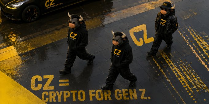 A promotional image featuring people in black CZ-branded hoodies and horned masks walking on a wet street with a car, accompanied by the text 'CZ = CRYPTO FOR GEN Z.'