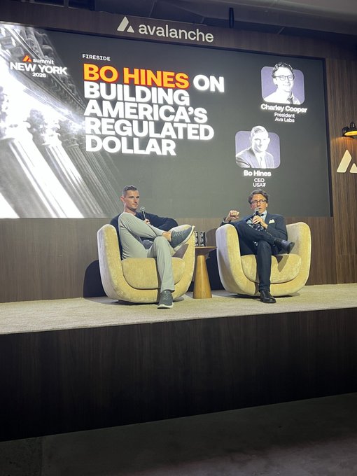 A fireside chat stage at 'Consensus NEW YORK 2025' by Avalanche, titled 'BO HINES ON BUILDING AMERICA'S REGULATED DOLLAR', featuring Charlie Cooper (President, Ave Labs) and Bo Hines (CEO, USDM).