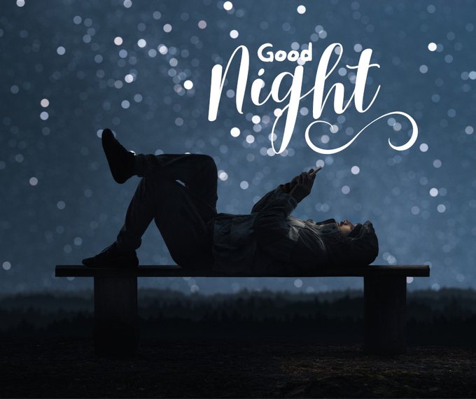 A silhouette of a person lying on a bench under a starry night sky, holding up a phone, with the text 'Good Night' elegantly displayed above.