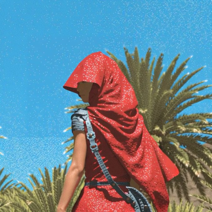 An image of a character wearing a red hooded cloak with shoulder armor, standing in front of a palm tree against a blue sky.