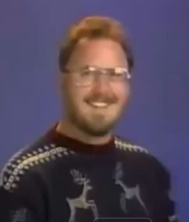 The image features a man wearing glasses, a sweater with deer designs, and smiling for the camera. The caption of the image reads "Your Moms token recently launched on Solana! Born on Trix_Market @trix_mrkt #MOMS #Solana". This suggests that the man is promoting or celebrating the launch of his Moms token on Solana, a popular cryptocurrency platform.