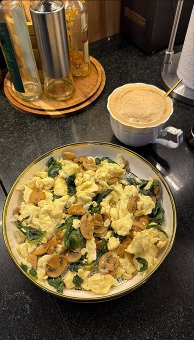 A plate of scrambled eggs with sautéed mushrooms and spinach sits next to a frothy cappuccino, intended as the day's highlight, but instead the morning was spent searching for content creators—@xora_finance is expanding its creator team with bounties ranging from $25 to $200+ per post on short-form videos, threads, and articles.